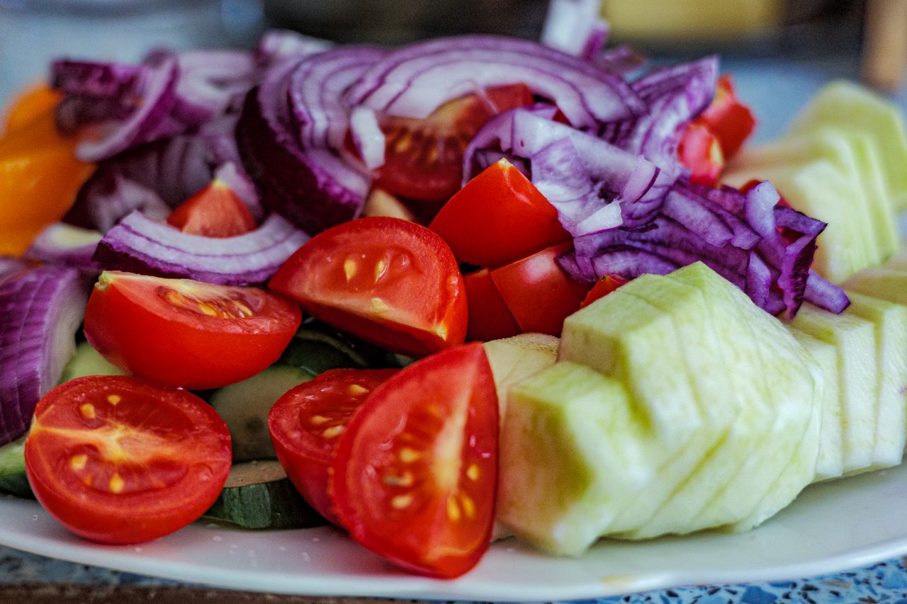 Crafting Captivating Headlines: Your awesome post title goes here Colorful summer vegetable salad featuring tomatoes, cucumbers, and red onion slices on a plate.